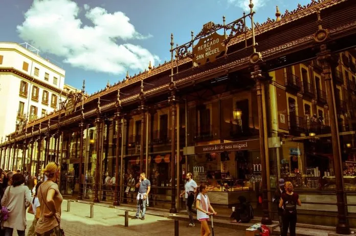 Mercado San Miguel Madrid exterior 1916 Art Nouveau iron glass architecture evening lights Plaza Mayor