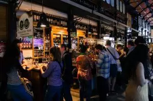Mercado San Miguel interior tapas stalls 30 vendors crowds standing room gourmet Madrid