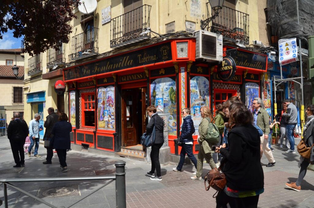 Traditional ceramic tile facade of Taberna La Fontanilla showcasing Jaime's Insider Tours in Madrid.
